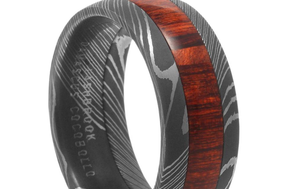 Damascus Steel Wedding Band with Cocobolo Wood<BR>Damascus Steel.  A centuries old metalsmithing technique involving multiple layers of hardened steel.  Paired with exotic Cocobolo Wood.  A unique ring for your man.