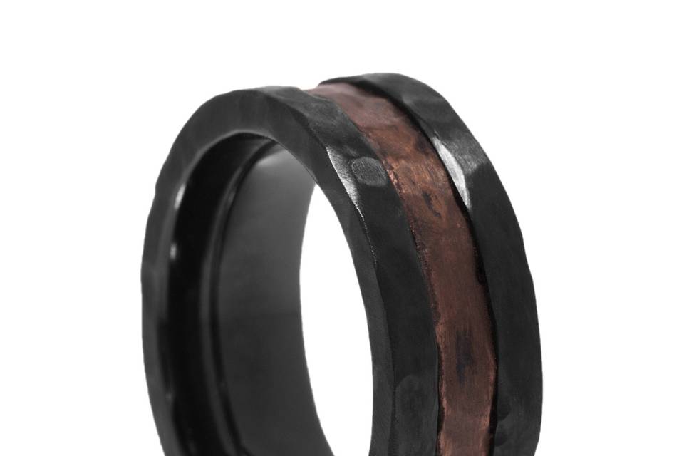 Black Zironium & Copper Wedding Band<br>Black and aged copper look remarkably well together.  The hammer finished black zironium has a rugged look.  The recessed center area is hammered copper.  A modern ring with a distressed look.