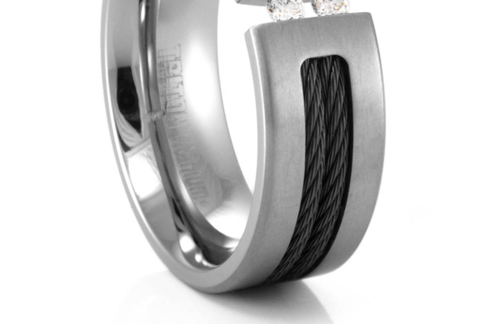 This TRITON titanium ring with Nitinol(black titanium) cable features two tension set diamonds. The different elements of the gray titanium, against the black cable and the white diamonds, creates a uniquely handsome ring. The diamonds are captivatingly held by the cross tension of the ring. Measuring a wide 8mm, and makes a great mens wedding band!