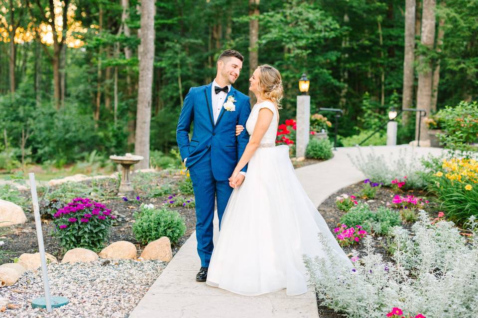 Bride and groom in barn garden