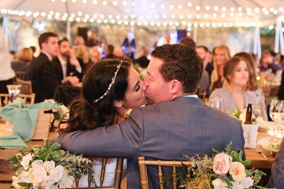 Newlyweds kiss during reception