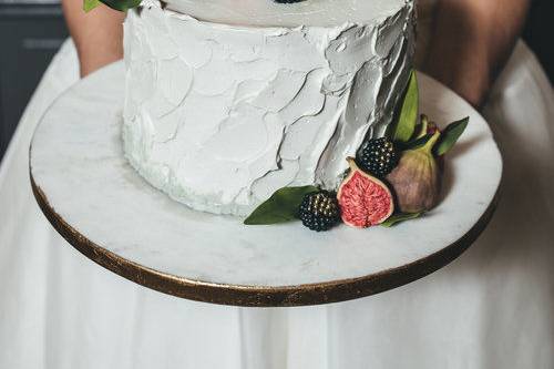 Bride holding cake