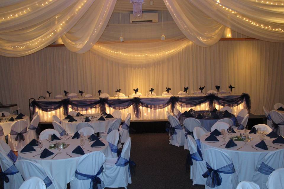 Lighted and Draped Head Table at Pine Peaks Event Center a member of Wedding Wire, The Knot, Brainerd Wedding Association, Twin Cities Bridal Show.