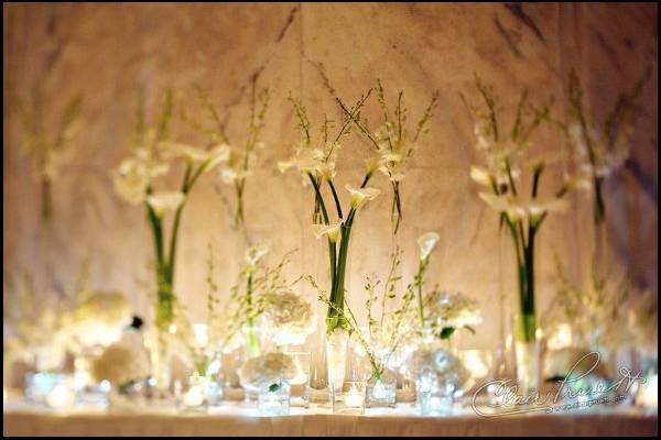 Arrangement of large white calla lilies, hydrangea, dendrobium orchids and floating candles.