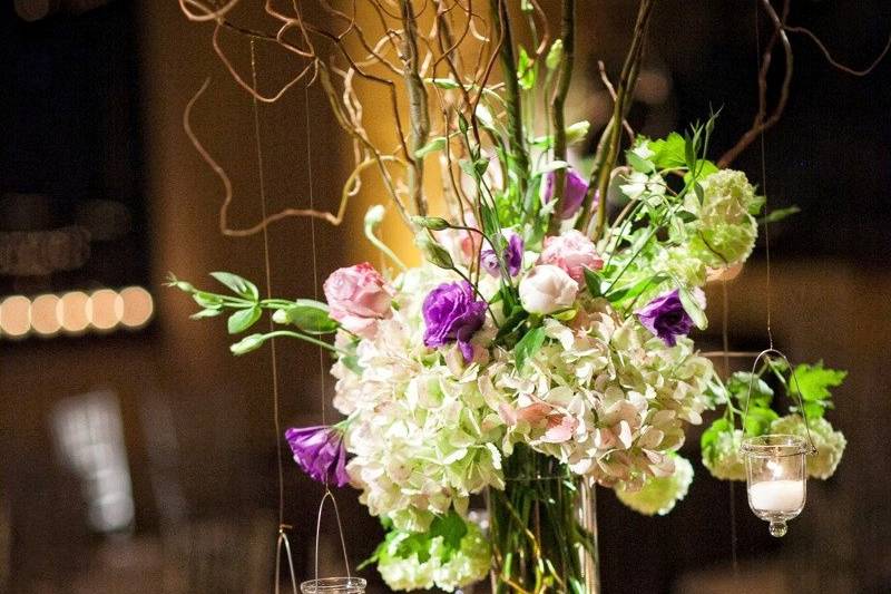 Tall centerpiece with hydrangea, viburnum, lisianthus,roses, branches and hanging votives