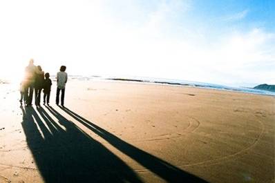 Walking together on the beach, shot with cross process and a fisheye lens