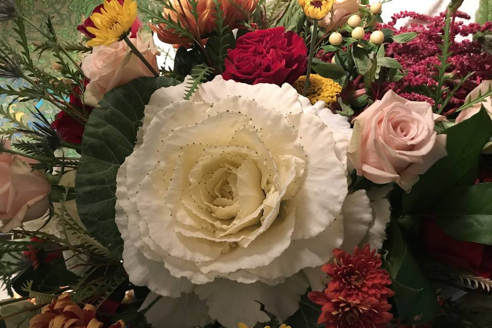 Beautiful arrangement with Kale, roses, and other flowers