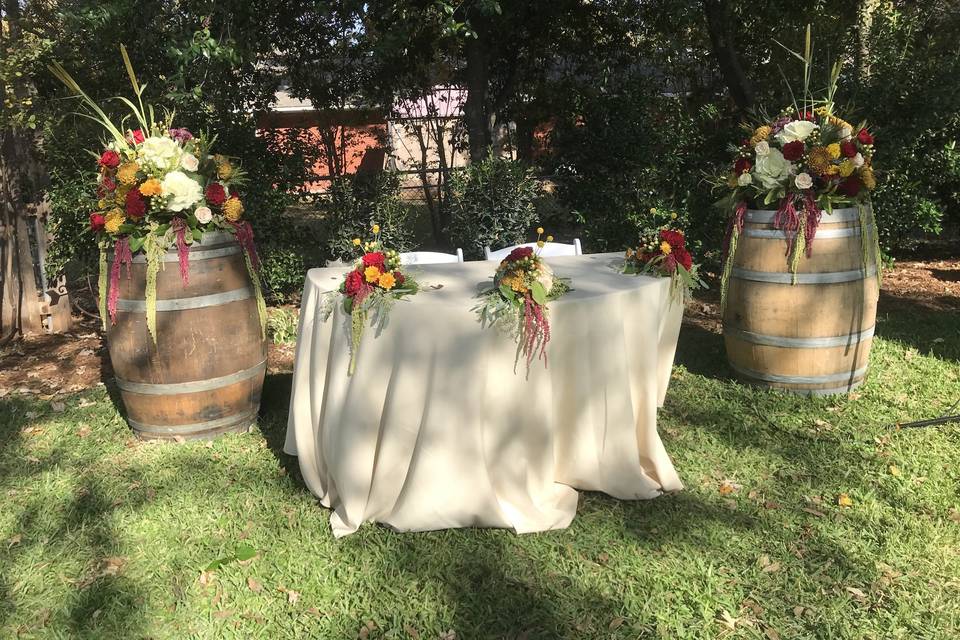 Sweetheart table with wine barrels and floral arrangments
Stephenville Wedding