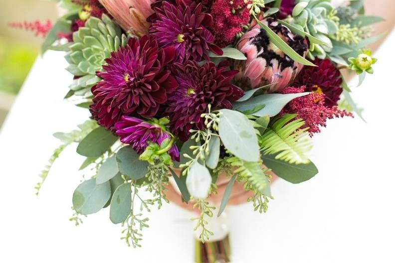 Protea and burgundy dahlias