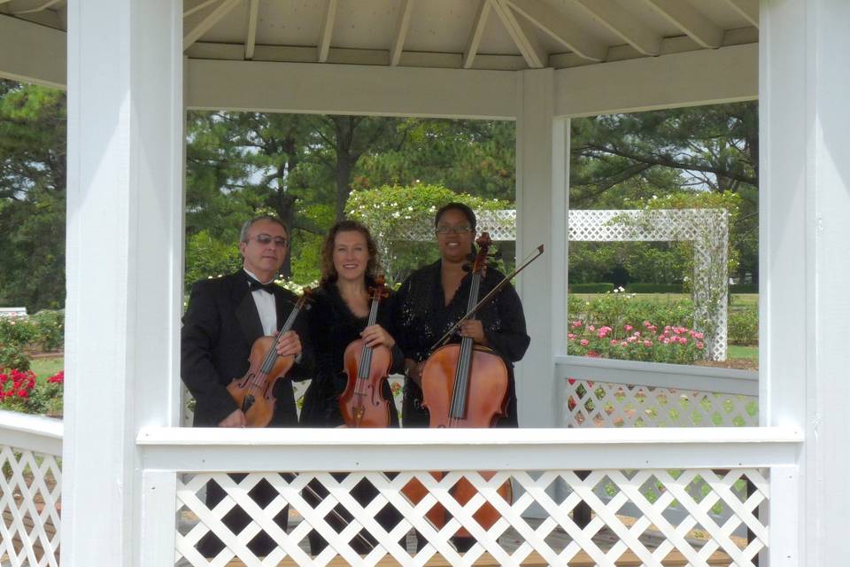 String trio standing in gazebo