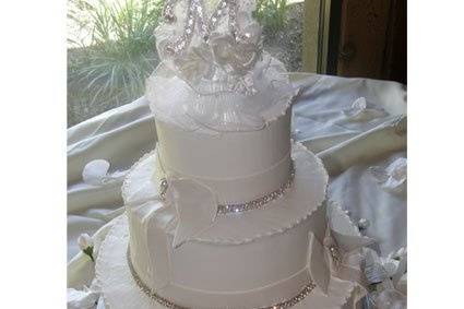 Tiered buttercream cake with fondant ribbon and bow.  Bling ribbon accent cake!