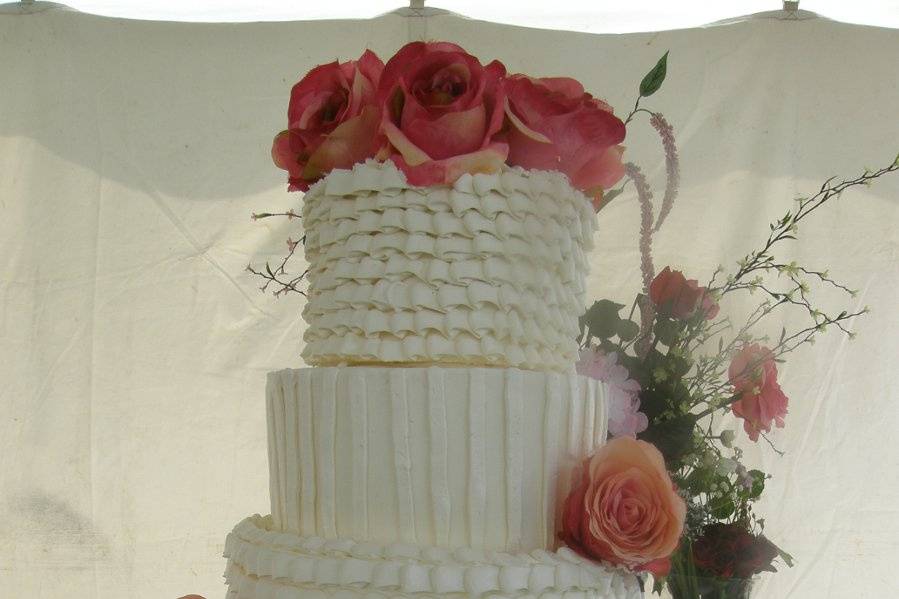 Buttercream tiered cake with alternating pattern design.