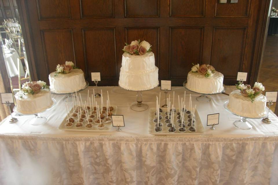 Combination of cake styles - individual cakes, two tiered cake and cake pops!  Bride requested a special icing pattern for the cakes.  Fresh roses