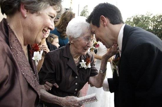 The groom shares a special moment with his grandmother moments after walking down the aisle with his bride.