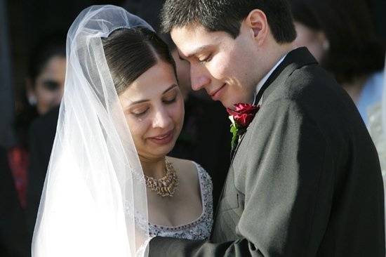 The groom comforts his bride as she tears up following the ceremony.