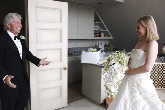 The father of the bride sees his daughter for the first time in her dress.