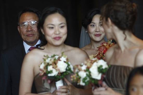 The bride gives her bridesmaid a nervous look moments before the start of the ceremony.