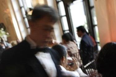 A member of the wait staff from McCall's Catering serves the main course to guest at the James Flood Mansion in San Francisco.