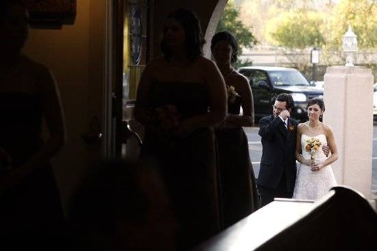 The father of the bride wipes a tear moments before walking his daughter down the aisle.