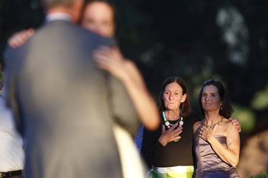 The mother of the bride(far right)and a friend watch the father daughter dance during a reception at Kunde Estates Winery.