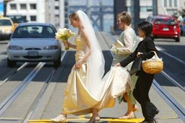 The bride crosses California Street on her way to her ceremony at Grace Cathedral.