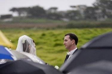 Rain falls during the exchange of vows between this bride and groom at Carmel Valley Ranch.