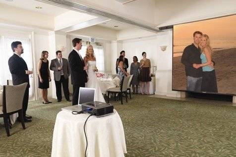Create a unique experience for your guests with a big screen viewing of your photo montage.