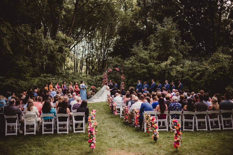 An outdoor ceremony surrounded by guests