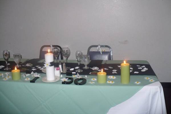 Holly and James's Sweetheart table.  We covered their table with lots of candles and silk rose petals and daisies.