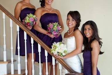 Bride with bridesmaids at staircase