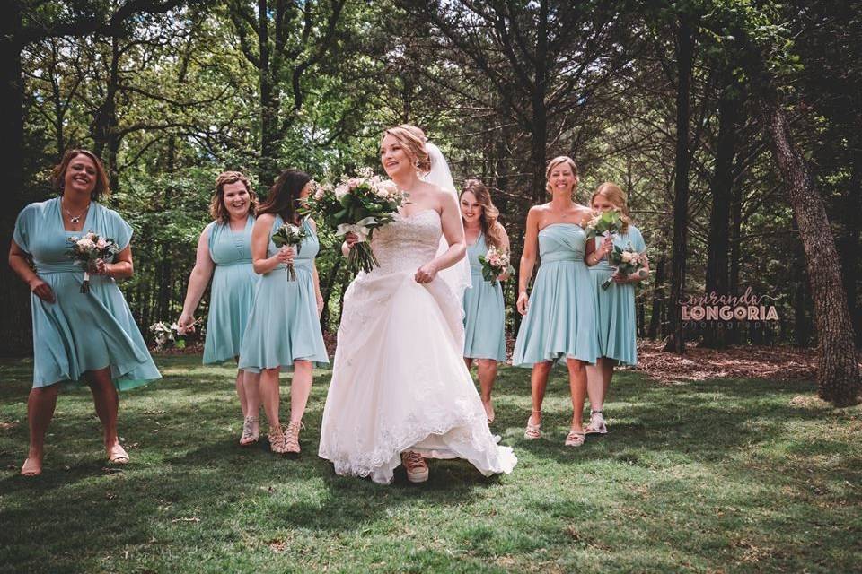 Bride and bridesmaids in a park | Photo credit Miranda Longoria Photography