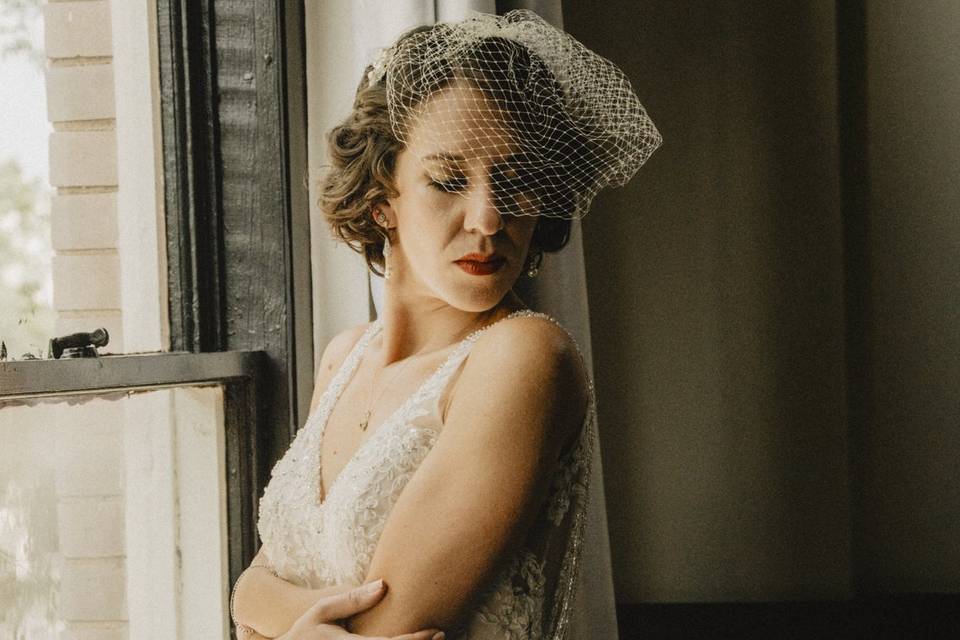 Bride posing by the window