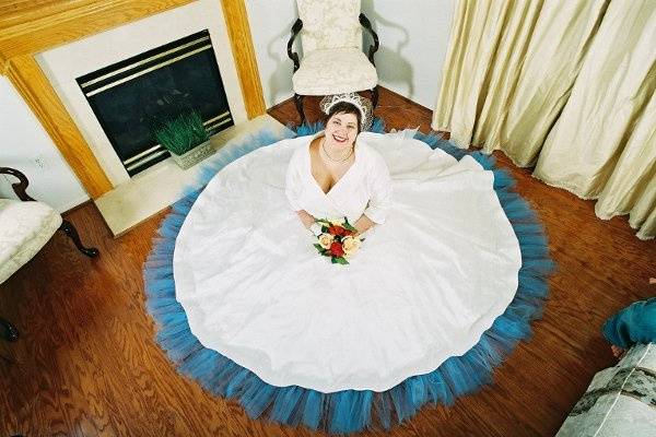 This gown is made of handkerchief linen and silk chiffon, accented with covered buttons and yards of silk organza ruffles.