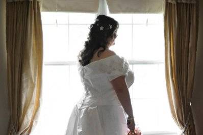 Silk taffeta with hand appliqued beaded lace.
Photo courtesy of www.balanceweddings.com