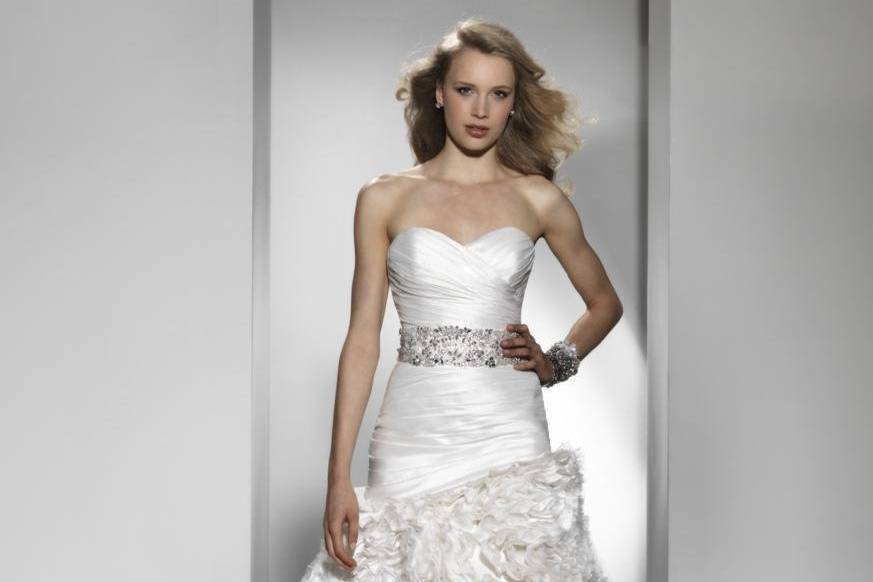 Style 9725- BackThis asymmetrical pleated silk dupion mermaid gown has lavishly encrusted beading throughout the Sabrina illusion neckline and back. Beaded buttons are placed over the back of the illusion neckline and cascade into silk and beaded buttons on the end of this chapel length train.