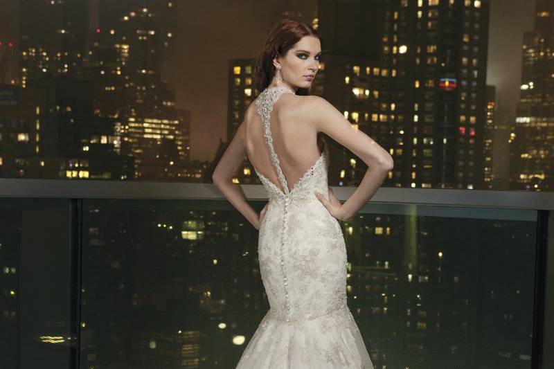 Style # 9746Hand embroidered beaded tulle ball gown with strapless neckline, basque waist and floating beaded appliques on a tulle skirt. The gown is finished with a corset back with beaded modesty piece and a chapel length train.
