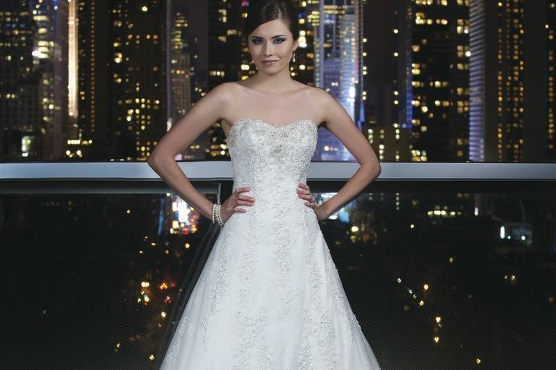 Style # 9752Silk Dupion ballgown with a chevron pleated bodice, sweetheart neckline and hand beaded moon stone cummerbund on a circular cut ball gown. The gown is finished with pockets and silk dupion and crystal buttons to the end of the chapel length train.