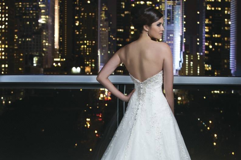 Style # 9752Silk Dupion ballgown with a chevron pleated bodice, sweetheart neckline and hand beaded moon stone cummerbund on a circular cut ball gown. The gown is finished with pockets and silk dupion and crystal buttons to the end of the chapel length train.
