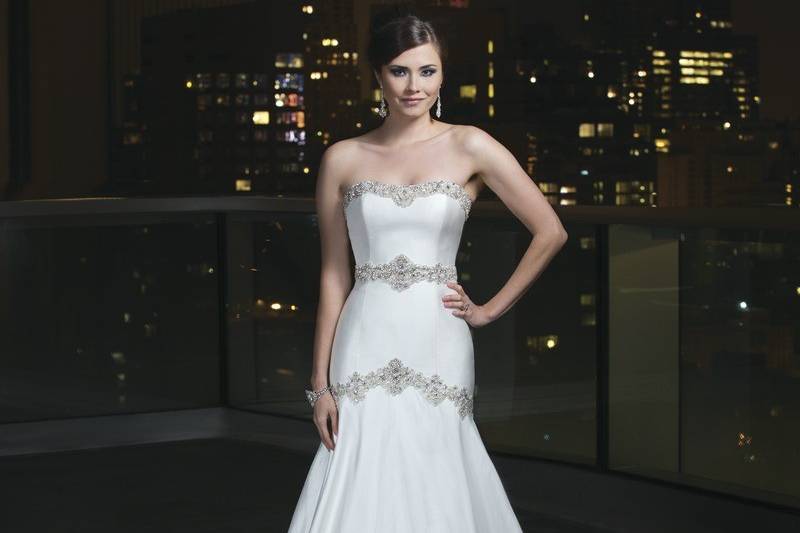 Style # 9754Hand beaded Alencon lace over satin trumpet gown featuring a jewel neckline, three quarter length sleeves and an attached pearl belt that highlights the natural waist. The gown is finished with tulle covered buttons to the back of the godet and a semi-chapel length train.