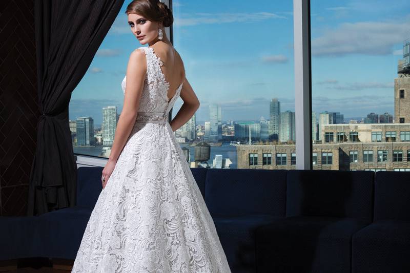 Style 9720A luxurious beaded sweetheart neckline and beaded trim at the natural waistline accent this layered lace fit and flare. Satin and beaded buttons cover the back zipper and continue to the end of the chapel length train