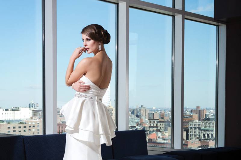 Style 9735Silk cotton satin mermaid silhouette features a heavily beaded illusionscoop neckline and cap sleeves. The beading continues throughout theillusion back neckline and jeweled and fabric buttons trail down thechapel length train. (Available in silk dupion as 9742)