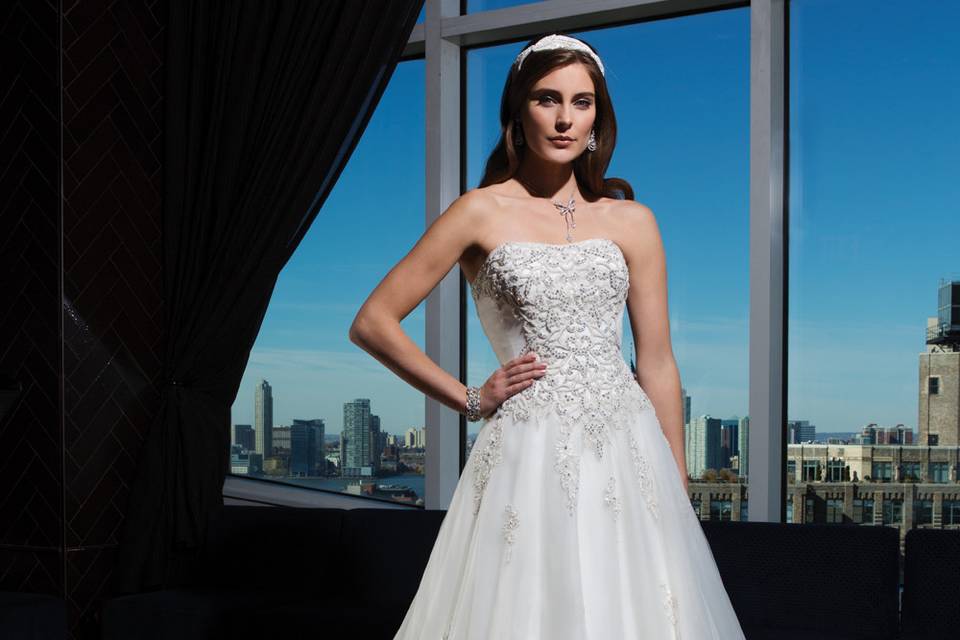 Style 9804 <br> Sleek couture seamed fit and flare gown in silk cotton satin features a portrait neckline and chapel length train.