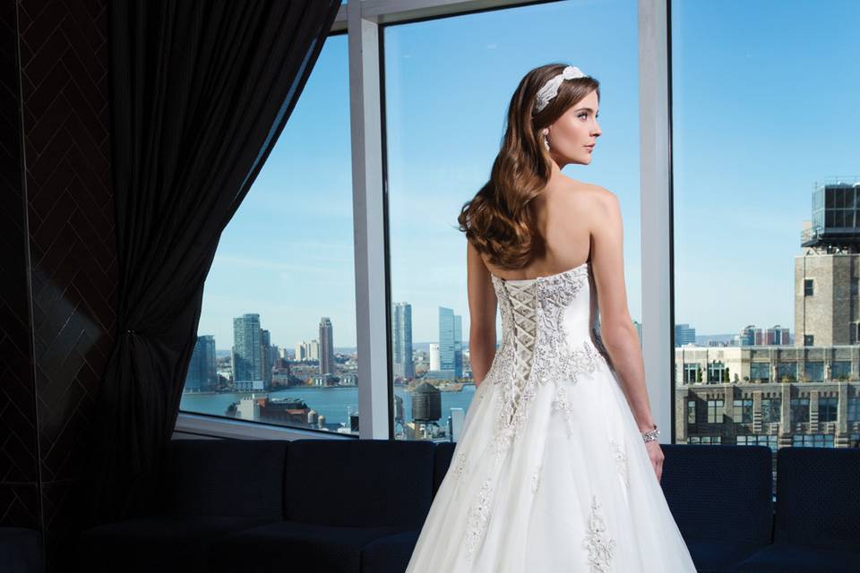 Style 9812 <br> Illusion sleeveless V-neckline, Chantilly lace underlay with Intricate hand beaded lace appliques and horsehair hem adorn this sleek mermaid gown.