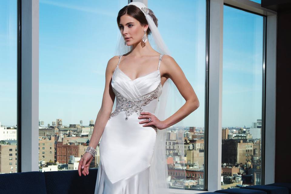 Style 9817 <br> This illusion Sabrina neckline fit and flare gown features long sleeves, intricate hand beading and an illusion back. This gown possesses attitude with its opulent beadwork.