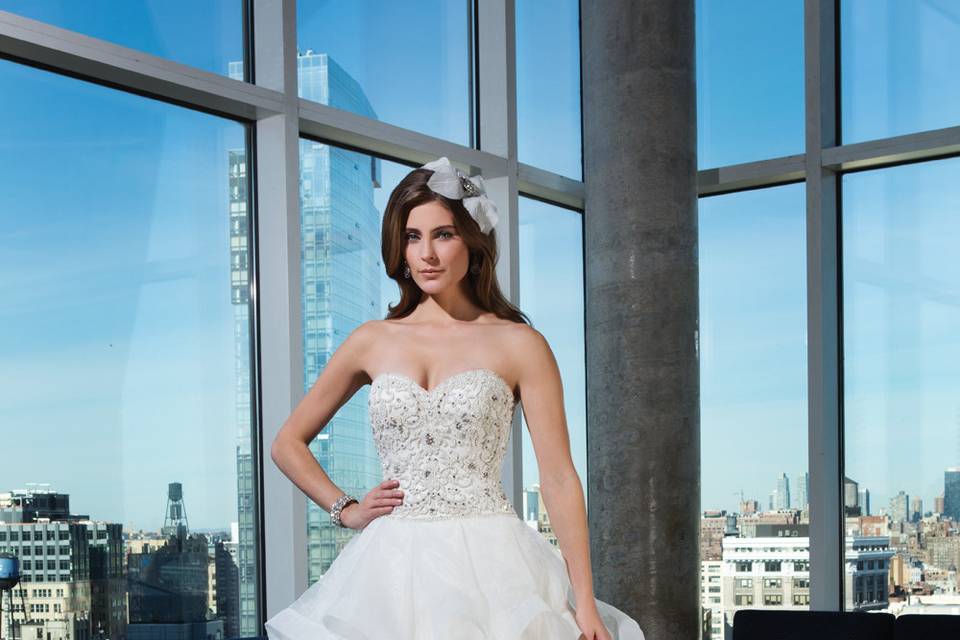 Style 9840 <br> A train meant for royalty. This strapless tulle ball gown has opulent beadwork on the bodice, a basque waistline, and a monarch length train.