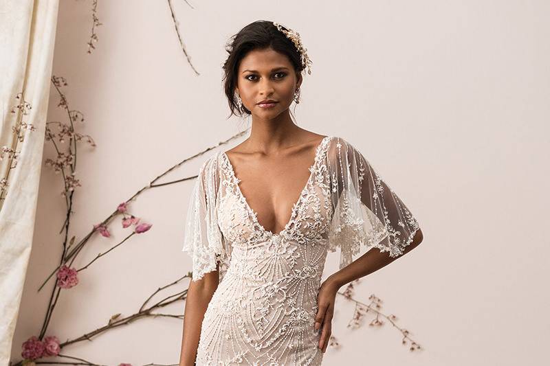 Justin Alexander Signature	9890	<br>	Feel modern and sleek in this beaded V-neckline with ornately beaded detachable flutter sleeves. Dance the night away in this unique hand beaded fit and flare with a deep open back and soft lining.