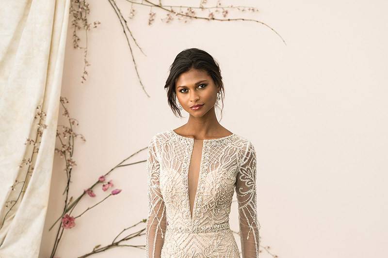 Justin Alexander Signature	9894	<br>	Your wedding day look will never be forgotten with this opulent beadwork that covers the sleeves, bodice and skirt of the gown. Lined with innovative stretch mesh. The hand beaded plunging Sabrina neckline matches the illusion back adorned with beading and working button closures.