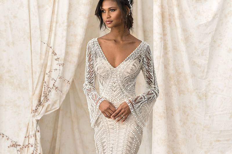 Justin Alexander Signature	9896	<br>	Step off the pages of fashion in this geometric, hand beaded design. Illusion bell sleeves are perfect for a touch of drama. Lined in stretch jersey, you will want to move all night. Working button closures finish the hand beaded illusion back.