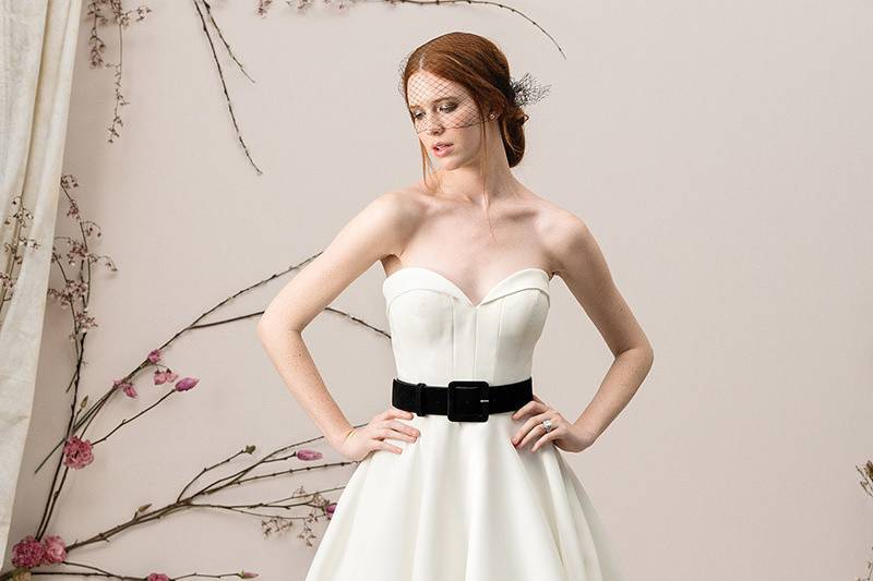 Justin Alexander Signature	9904	<br>	A unique, lavish Satin ball gown. Couture embodies the envelope neckline and statement seaming on the bodice. Accented with a black detachable belt. The soft lavish Satin with pockets flows to the floor to a finished bias hem band.