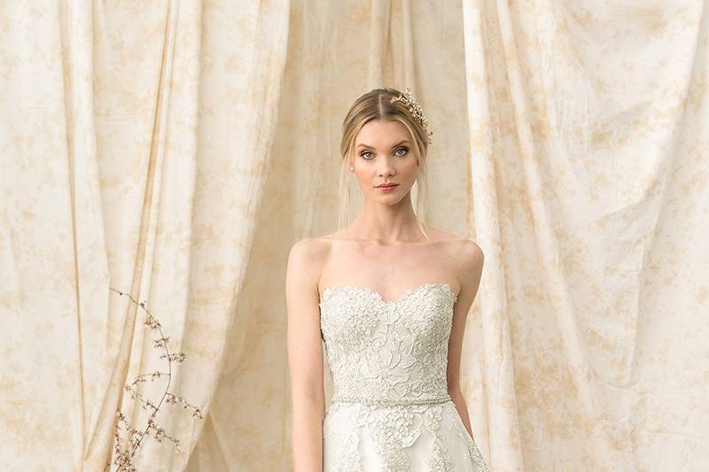 Justin Alexander Signature	9907	<br>	Modern luxury is created by this soft sweetheart neckline gown with natural waistline. Hand embroidered lace adorns the bodice to the A-line skirt. Paired with a delicately opulent self-tie belt.